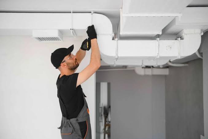 Technician conducting HVAC equipment inspection and diagnostics in Maywood