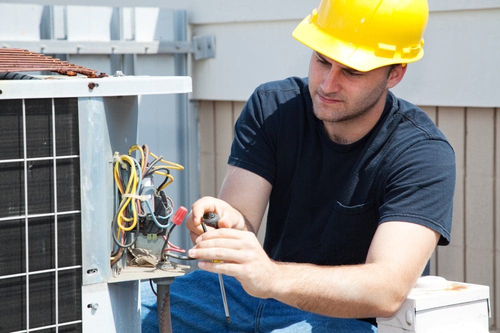 HVAC technician servicing residential air conditioning equipment in Maywood California