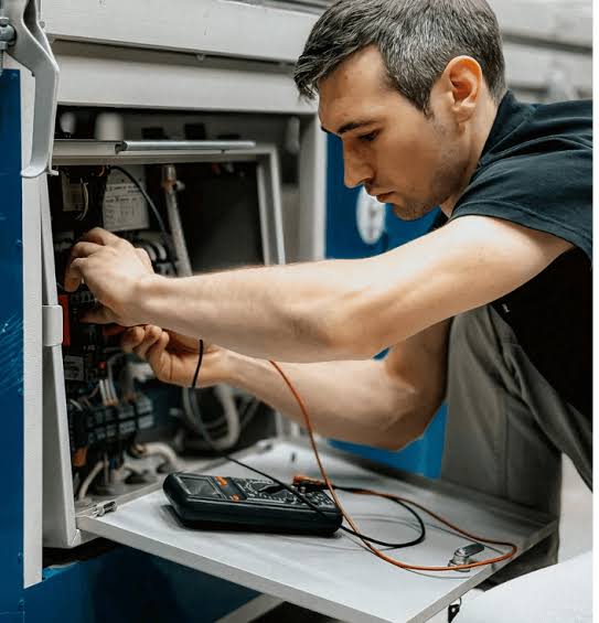 HVAC technician performing system diagnostics and repair